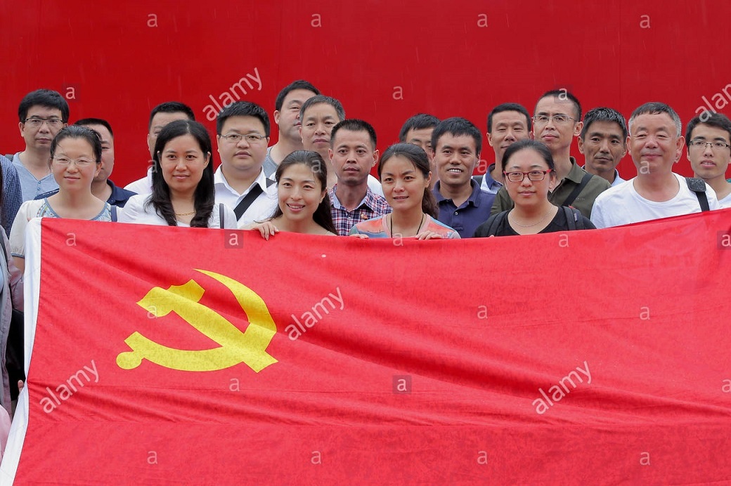 file-chinese-members-of-the-communist-party-of-china-cpc-pose-with-a-party-flag-to-celebra